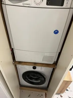 a washer and dryer on a shelf in a room at Comfort Airport Metro Suite in Sofia
