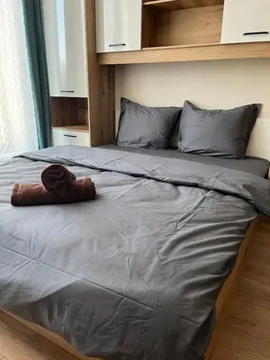 a bed with a towel on top of it at Comfort Airport Metro Suite in Sofia