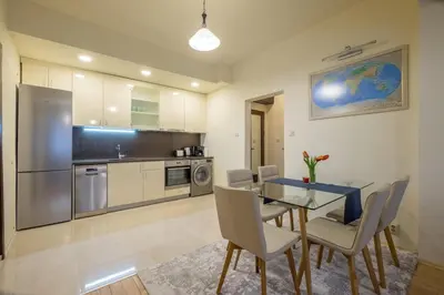 a kitchen and dining room with a table and chairs at Stylish TOP center Flat 100m to Vitosha blvd in Sofia