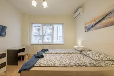 a bedroom with a bed with a teddy bear on it at Stylish TOP center Flat 100m to Vitosha blvd in Sofia