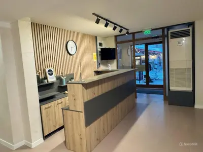 a kitchen with a counter and a clock on the wall at Dream View Family Retreat in Pamporovo