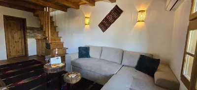 a living room with a couch and two tables at Вили Панорама Лещен in Leshten