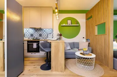 a small kitchen and living room with a blue couch at Bright & Cozy Studio in Plovdiv by Flat Mаnager in Plovdiv