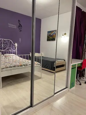 a room with a bed and a mirror at Art city studio in Sofia center in Sofia