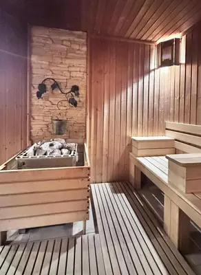 a sauna with a tub and two benches in it at Elegance28 - Stylish Mountain Retreat in Bansko by Flat Mаnager in Bansko