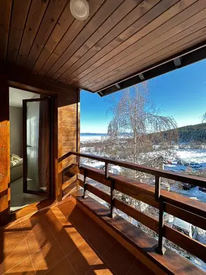 a room with a balcony with a view at Elegance28 - Stylish Mountain Retreat in Bansko by Flat Mаnager in Bansko