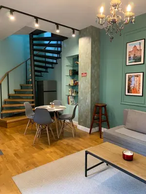 a living room with a table and a couch at Cozy townhouse in the heart of Sofia in Sofia