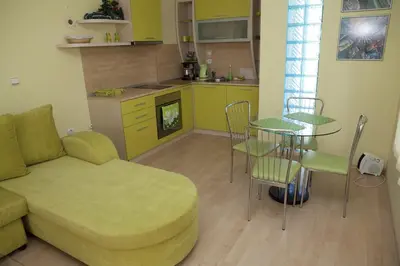 a living room with a couch and a table and a kitchen at Spa Villa Crystal in Hisarya