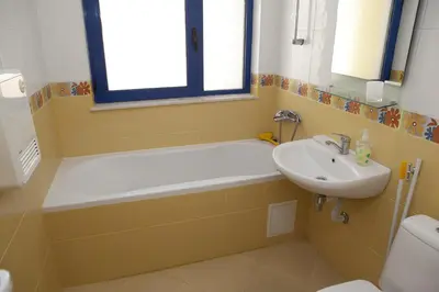 a bathroom with a bath tub and a sink at Spa Villa Crystal in Hisarya