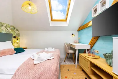 a bedroom with a bed and a desk and a sink at Kapana Art Sky Studios Parking Included in Plovdiv