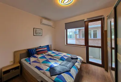 a bedroom with a bed and a window at Next to Kapana - Art Apartment in Plovdiv