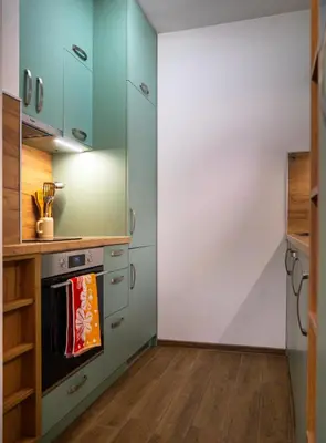 a kitchen with green cabinets and an oven at Next to Kapana - Art Apartment in Plovdiv