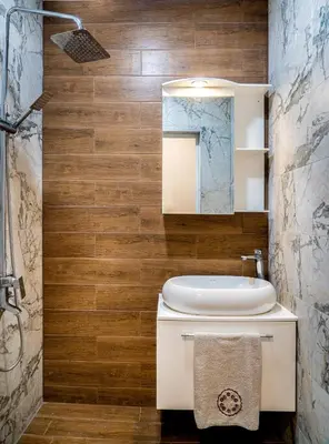 a bathroom with a white toilet and a sink at Next to Kapana - Art Apartment in Plovdiv