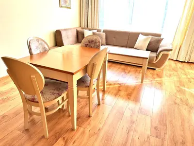 a living room with a table and chairs and a couch at Cite Jardin in Sofia