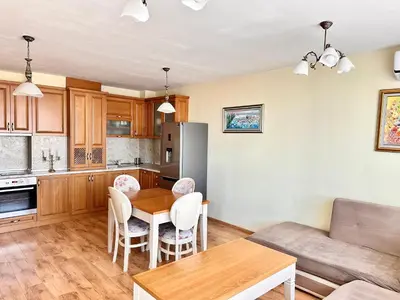 a kitchen and living room with a table and chairs at Cite Jardin in Sofia