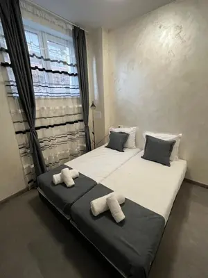 two beds in a room with towels on them at BoxRoom2 in Kyustendil