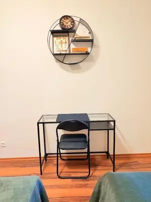 a glass desk with a chair in a room at GREEN STAR Grand Resort Pamporovo in Pamporovo