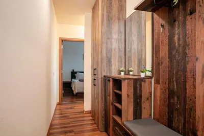 a hallway with wooden walls and a room with a bed at GREEN STAR Grand Resort Pamporovo in Pamporovo