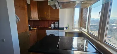 a kitchen with a sink and a counter top with a window at Home away from home in Sofia