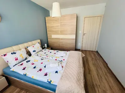 a bedroom with a bed with white sheets and pillows at Prima apartment in Sofia