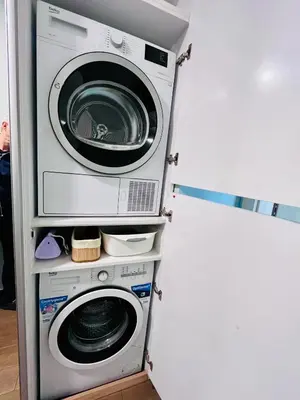 a washing machine and a washer and dryer in a room at Prima apartment in Sofia