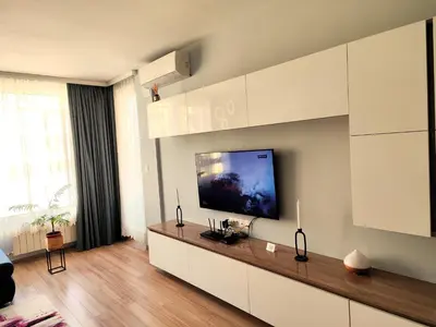 a living room with a flat screen tv on a wall at Prima apartment in Sofia