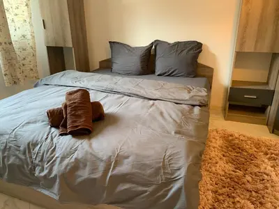 a bed with two stuffed animals sitting on it at Urban Nest Lulin in Sofia