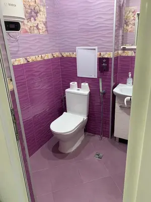 a purple bathroom with a toilet and a sink at Urban Nest Lulin in Sofia
