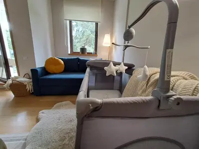 a living room with a blue couch and a lamp at Rila Mountain Design Studio, Borovets, Shiroka poliana 216 in Borovets