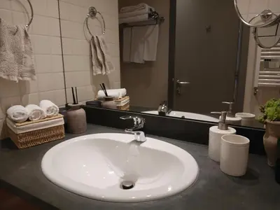 a bathroom with a white sink and a mirror at Rila Mountain Design Studio, Borovets, Shiroka poliana 216 in Borovets