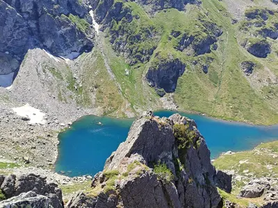 an aerial view of a mountain with a blue lake at Rila Mountain Design Studio, Borovets, Shiroka poliana 216 in Borovets