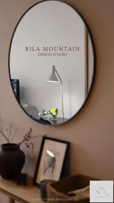 a mirror on a wall with a table with a lamp at Rila Mountain Design Studio, Borovets, Shiroka poliana 216 in Borovets