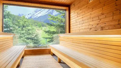 a sauna with a large window with a mountain view at Luxfjäll Ivan Rilski - Full Spa & Pool in Bansko
