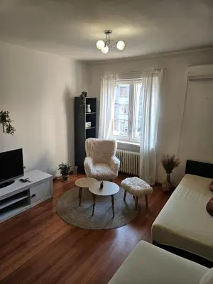 a living room with a chair and a coffee table at City Center Park Apartment in Sofia
