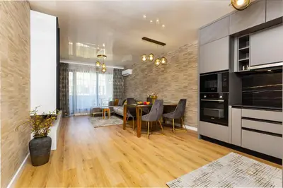 a kitchen with a table and a dining room at Two-Bedroom Apartments with Free Private Parking and 6min to Center in Plovdiv