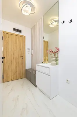 a bathroom with a sink and a wooden door at Two-Bedroom Apartments with Free Private Parking and 6min to Center in Plovdiv