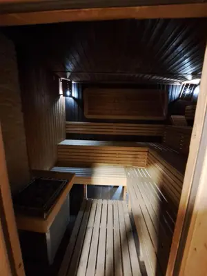 an inside of a sauna with a wooden floor at ВасиленаАпарт in Pamporovo