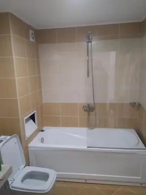 a bathroom with a white tub and a toilet at Георгиев Луксури Апарт in Pamporovo