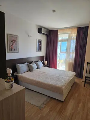 a bedroom with a large bed and a window at Pampo-Heaven in Smolyan