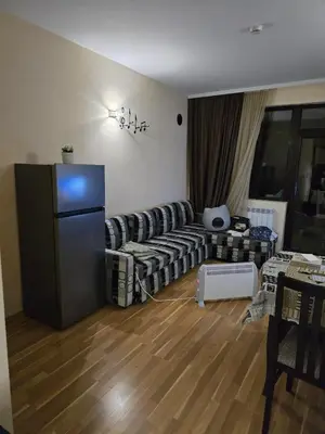 a living room with a couch and a refrigerator at Pampo-Heaven in Smolyan