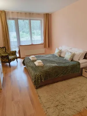 a bedroom with a bed with two towels on it at Evrika home 4 in Pamporovo