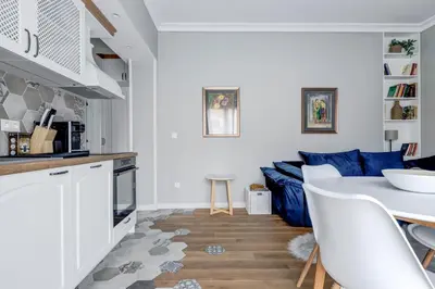 a kitchen and living room with a table and a couch at Quiet One-Bedroom Hеaven Relax and Unwind in Sofia