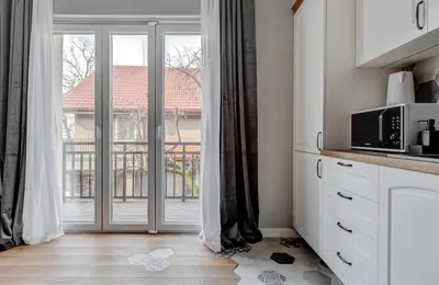 a kitchen with a door open to a balcony at Quiet One-Bedroom Hеaven Relax and Unwind in Sofia