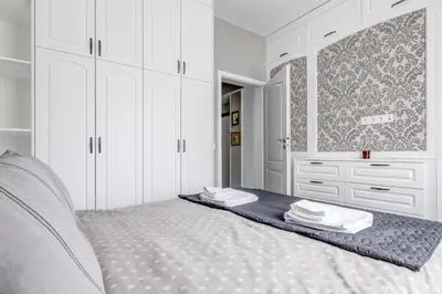a white bedroom with a bed with white cabinets at Quiet One-Bedroom Hеaven Relax and Unwind in Sofia