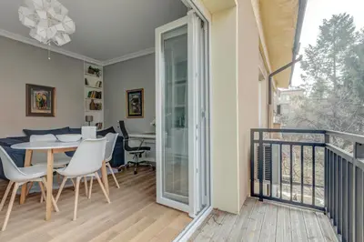 a room with a balcony with a table and chairs at Quiet One-Bedroom Hеaven Relax and Unwind in Sofia