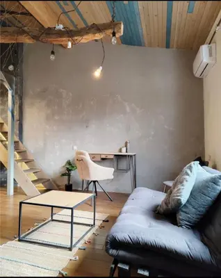 a living room with a couch and a table at Graf's Prestige Duplex in Sofia