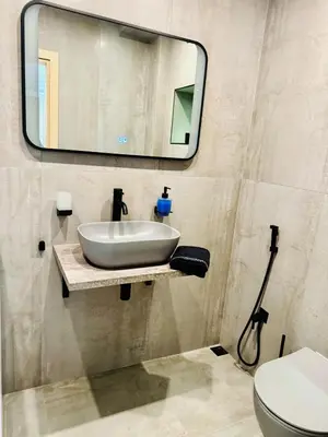 a bathroom with a sink and a mirror at luxuri suite ''dezodava'' in Sandanski