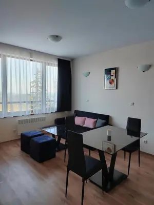 a living room with a table and a couch at Mountain Ski & SPA apartment in Pamporovo