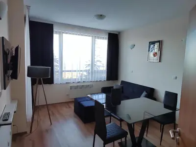 a small living room with a table and chairs at Mountain Ski & SPA apartment in Pamporovo