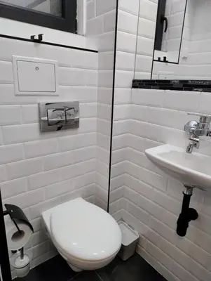 a white bathroom with a toilet and a sink at Tiny studio in top center in Sofia